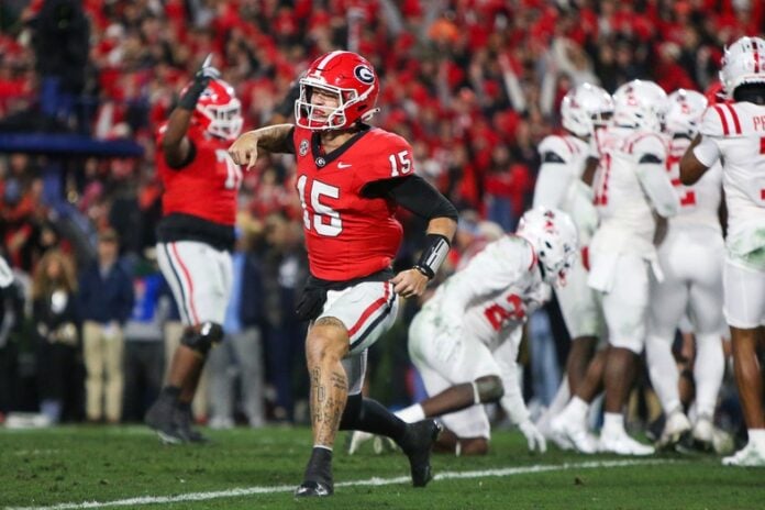Georgia Bulldogs quarterback Carson Beck (15) celebrates after a touchdown against the Mississippi Rebels in the second quarter at Sanford Stadium.