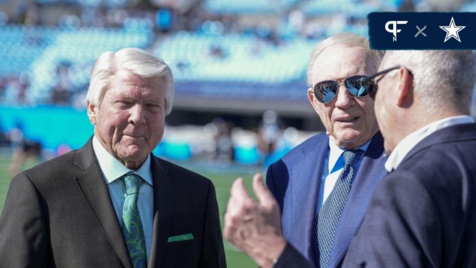 Cowboys owner Jerry Jones chats with announcer and former coach Jimmie Johnson during pregame warm ups between the Carolina Panthers and the Dallas Cowboys at Bank of America Stadium.