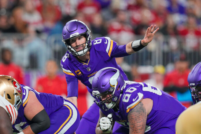 Minnesota Vikings quarterback Kirk Cousins (8) signals his team against the San Francisco 49ers in the third quarter at U.S. Bank Stadium.