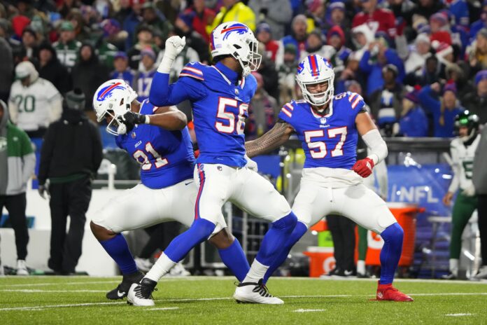Buffalo Bills defensive tackle Ed Oliver (91) and defensive end Leonard Floyd (56) and defensive end AJ Epenesa (57) celebrate getting a sack against the New York Jets during the second half at Highmark Stadium.