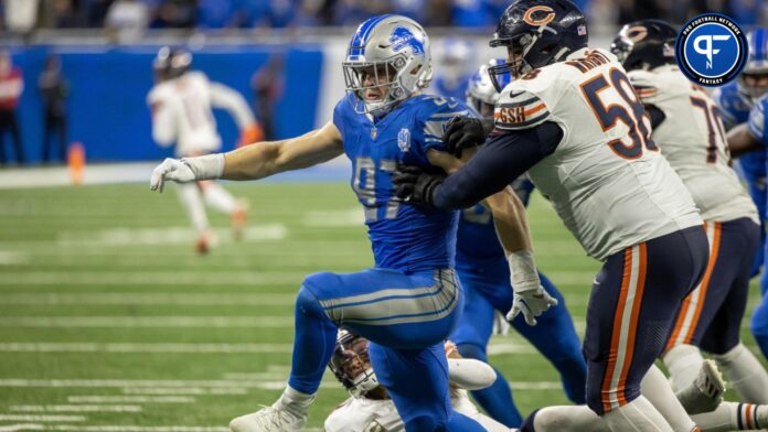 Aidan Hutchinson (97) gets inside position on Chicago Bears offensive tackle Darnell Wright (58) and smacks the football out of the hands of quarterback Justin Fields (1) and chases after the loose ball late in the fourth quarter at Ford Field.