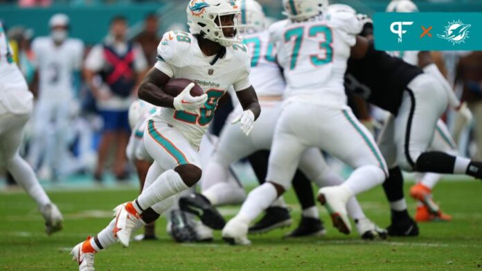Miami Dolphins running back De'Von Achane (28) runs with the ball against the Las Vegas Raiders during the first half at Hard Rock Stadium.