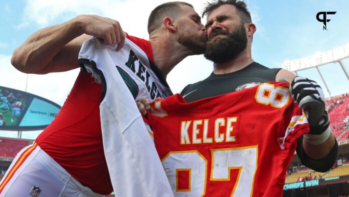 Kansas City Chiefs tight end Travis Kelce (87) kisses Philadelphia Eagles center Jason Kelce (62) after the game at Arrowhead Stadium.