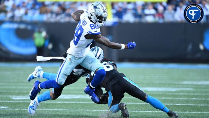 Dallas Cowboys wide receiver CeeDee Lamb (88) with the ball as Carolina Panthers linebacker Frankie Luvu (49) and cornerback Donte Jackson (26) defend in the fourth quarter at Bank of America Stadium.