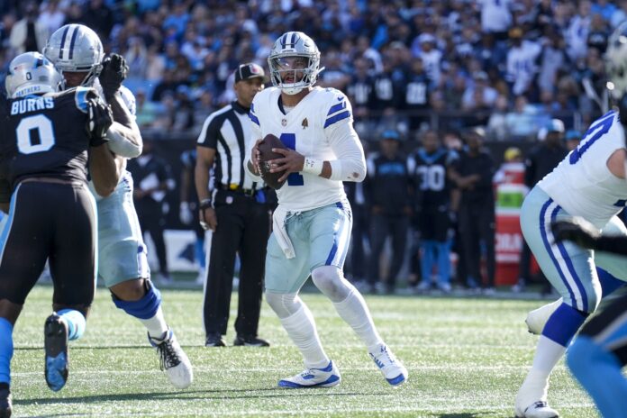 Dallas Cowboys quarterback Dak Prescott (4) drops back to pass against the Carolina Panthers during the second quarter at Bank of America Stadium.