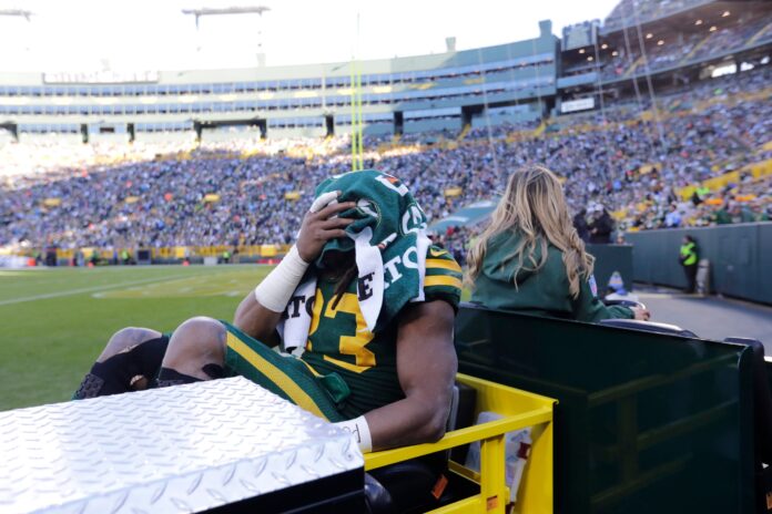 Aaron Jones (33) is carted off the field after getting injured in the second quarter against the Los Angeles Chargers.