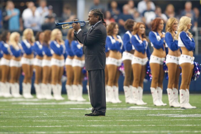 Freddie Jones plays the national anthem on the field before the game between the Dallas Cowboys and the New York Giants at AT&T Stadium.