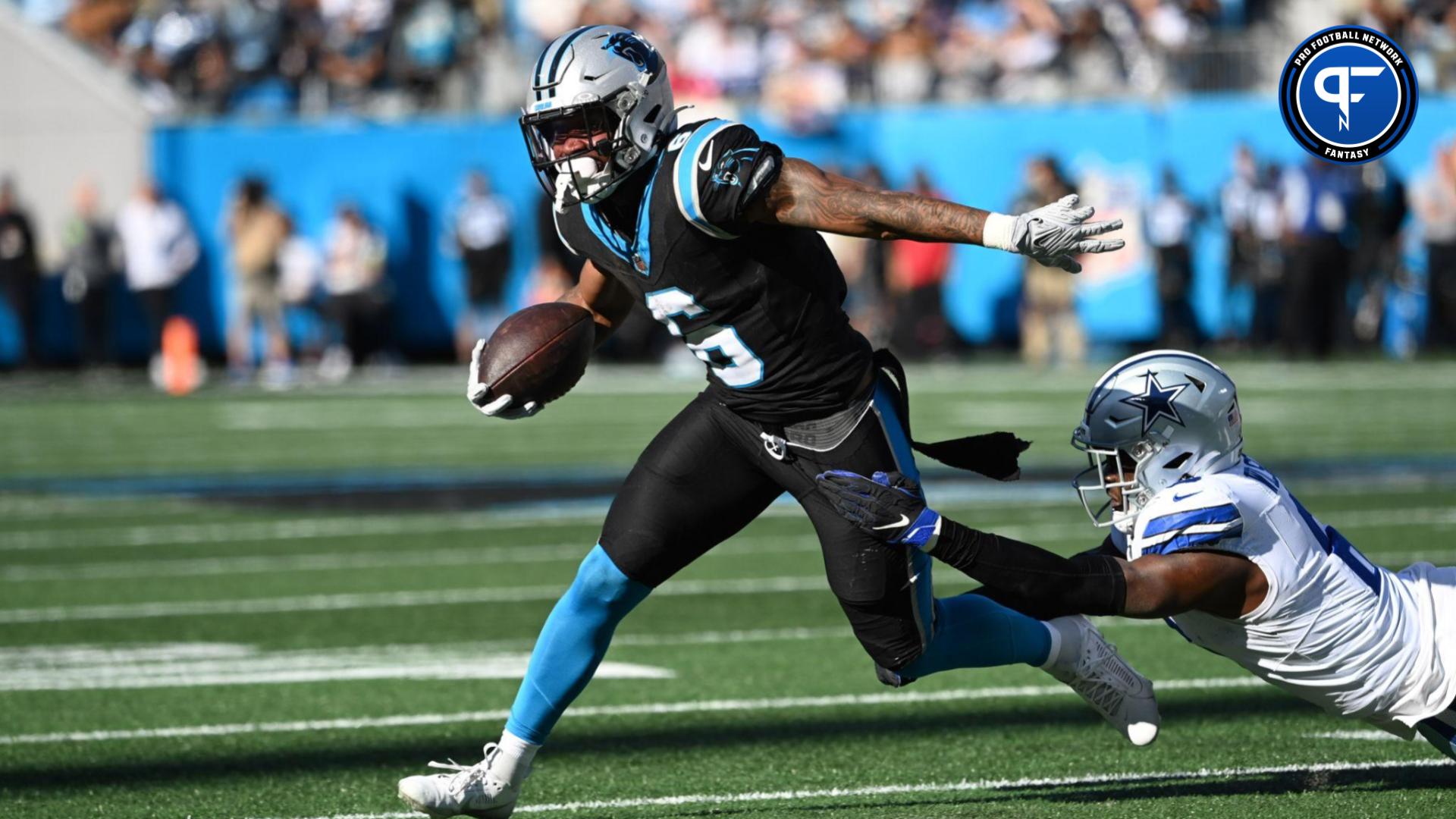 Carolina Panthers running back Miles Sanders (6) with the ball as Dallas Cowboys safety Donovan Wilson (6) defends in the second quarter at Bank of America Stadium.