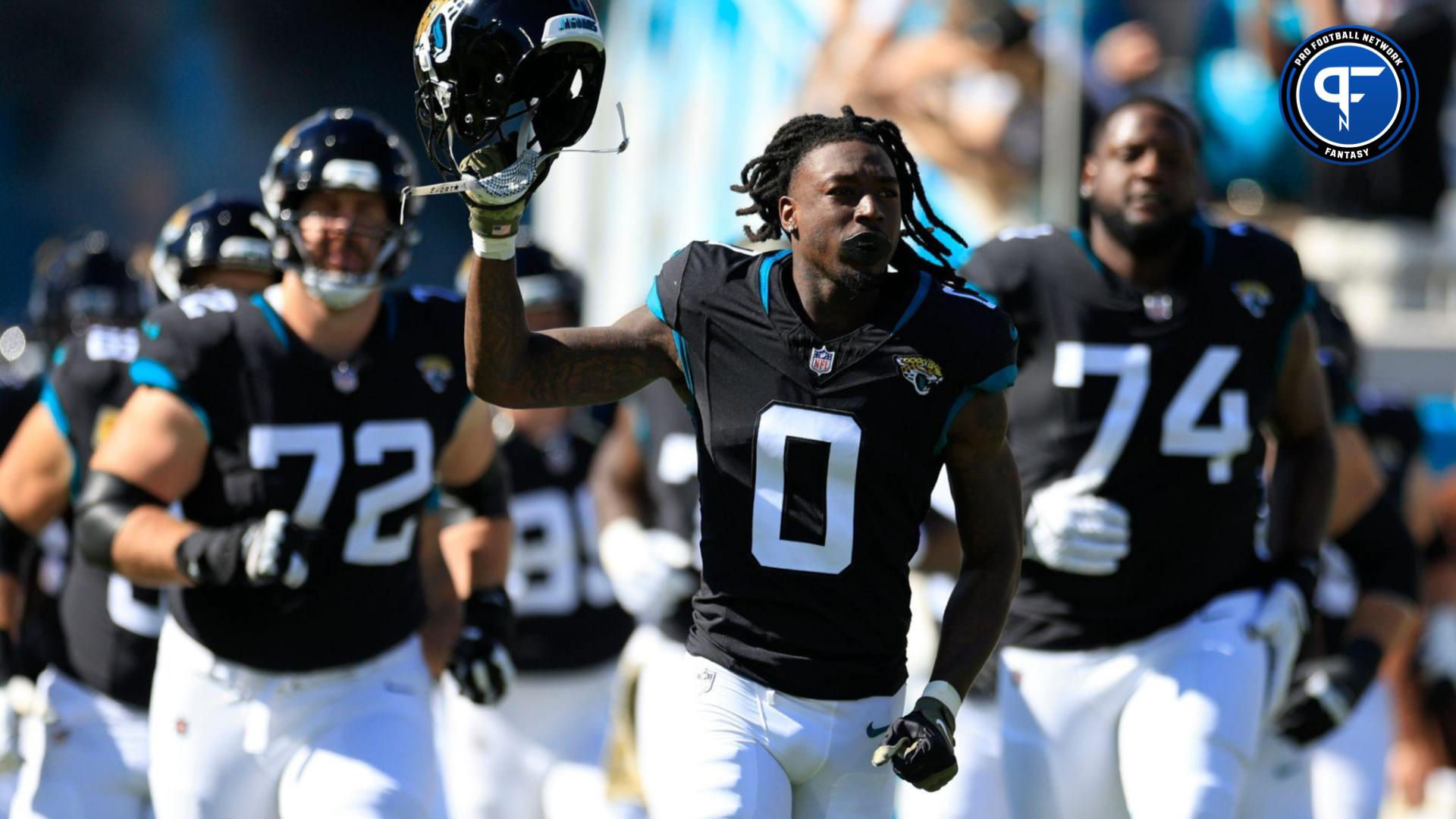 Jacksonville Jaguars wide receiver Calvin Ridley (0) leads his team onto the field before an NFL football matchup.
