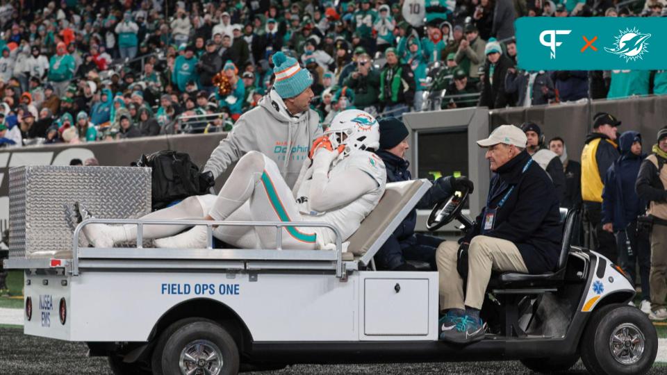 Jaelan Phillips (15) is driven off the field after an apparent injury during the second half against the New York Jets at MetLife Stadium.