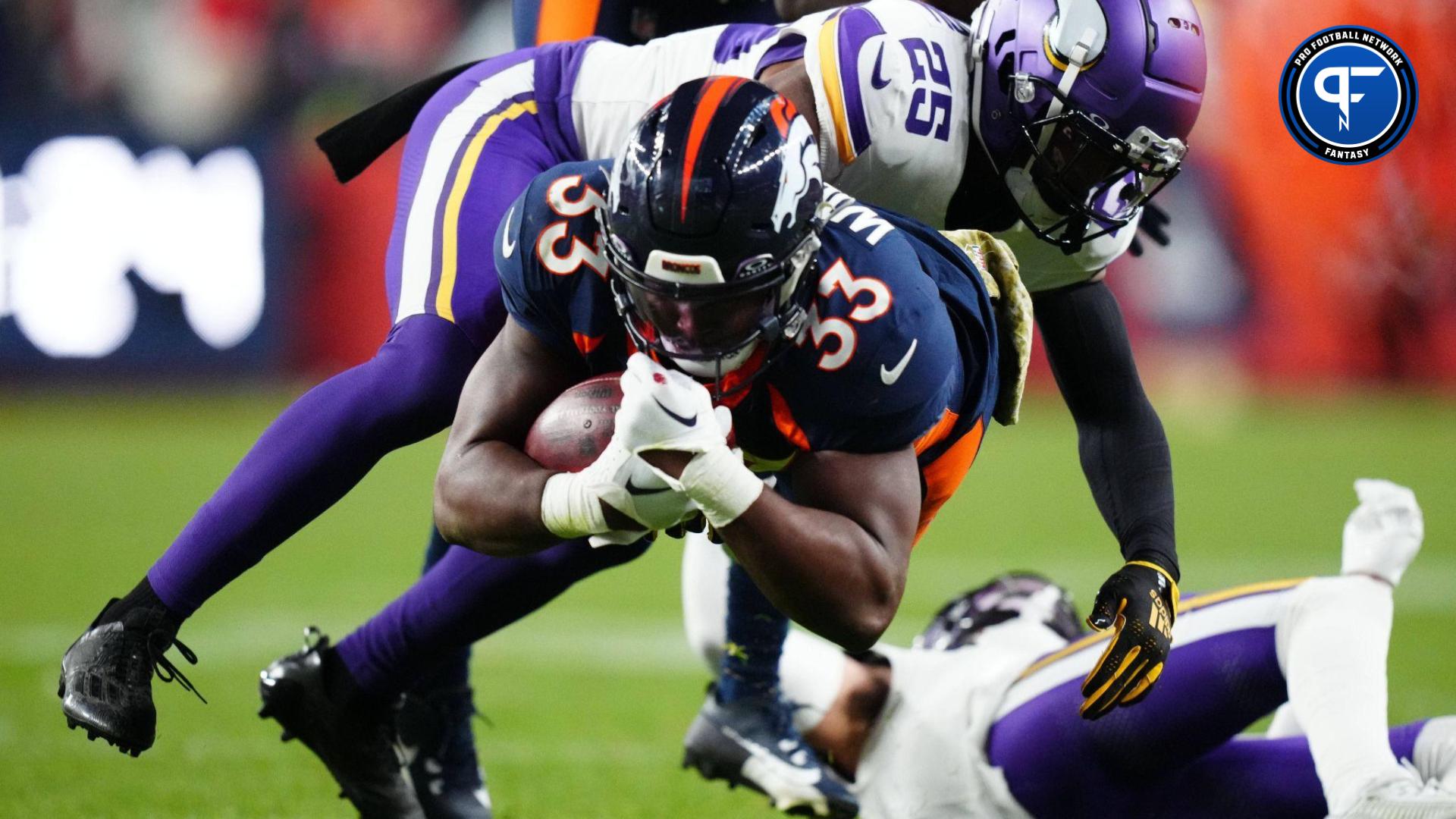 Minnesota Vikings safety Theo Jackson (25) tackles Denver Broncos running back Javonte Williams (33) in the fourth quarter at Empower Field at Mile High.