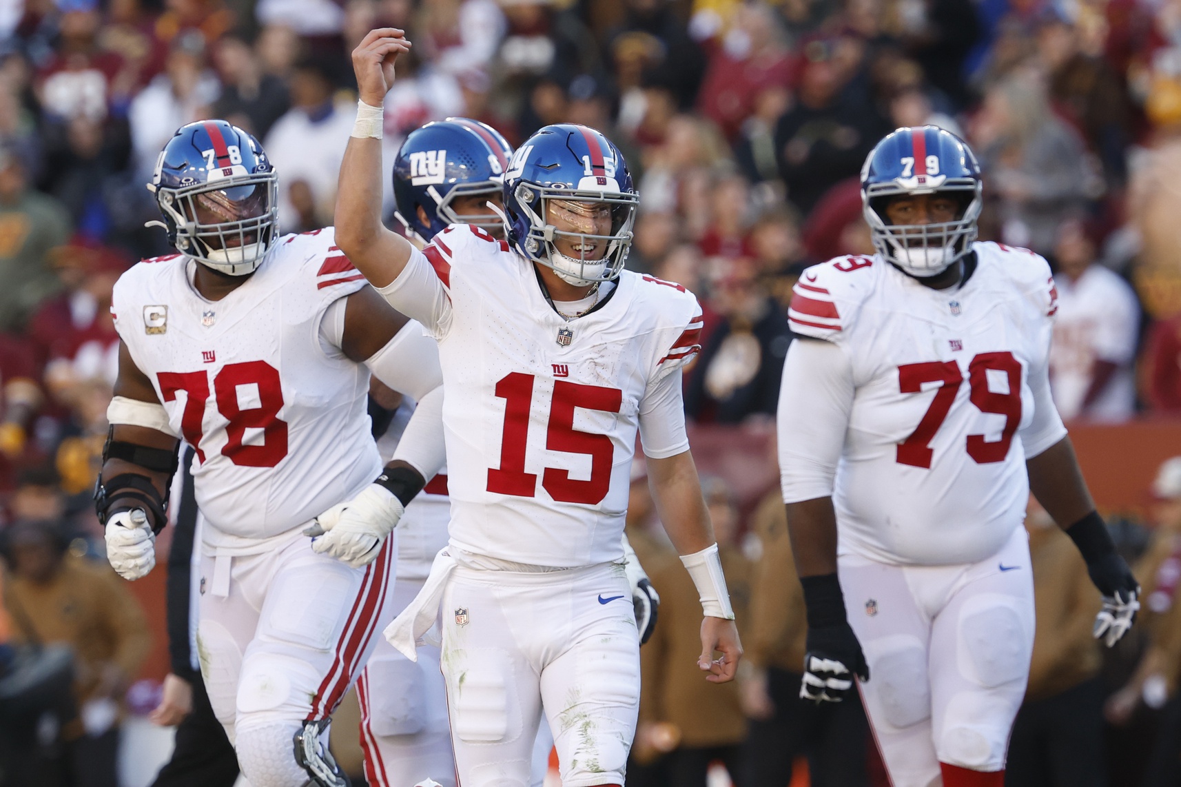 New York Giants QB Tommy DeVito (15) celebrates with teammates after throwing a touchdown pass against the Washington Commanders.