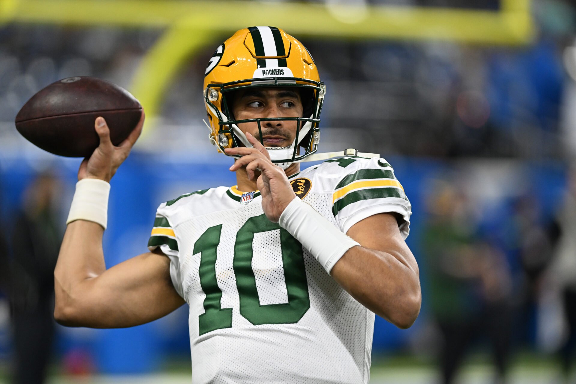 Green Bay Packers quarterback Jordan Love (10) throws passes during pregame warmups before their game against the Detroit Lions at Ford Field.