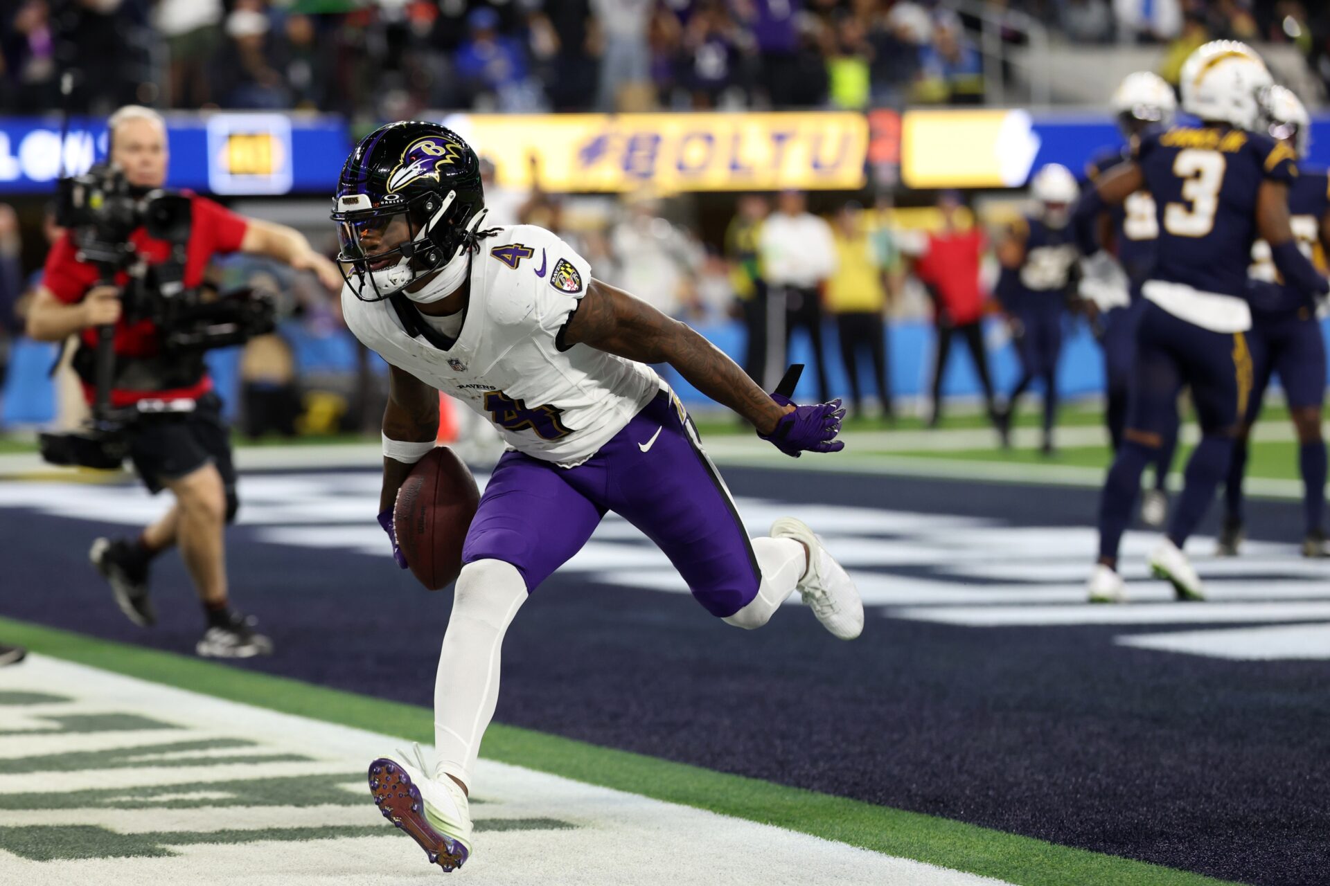 Baltimore Ravens wide receiver Zay Flowers (4) reacts after catching a touchdown pass during the second quarter against the Los Angeles Chargers at SoFi Stadium.