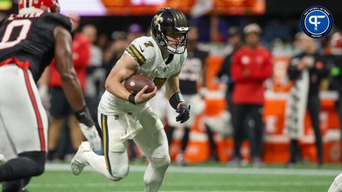 Taysom Hill (7) runs the ball against the Atlanta Falcons in the second half at Mercedes-Benz Stadium.