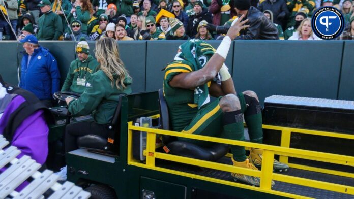 Aaron Jones (33) waves to the crowd as he's carted off the field against the Los Angeles Chargers.