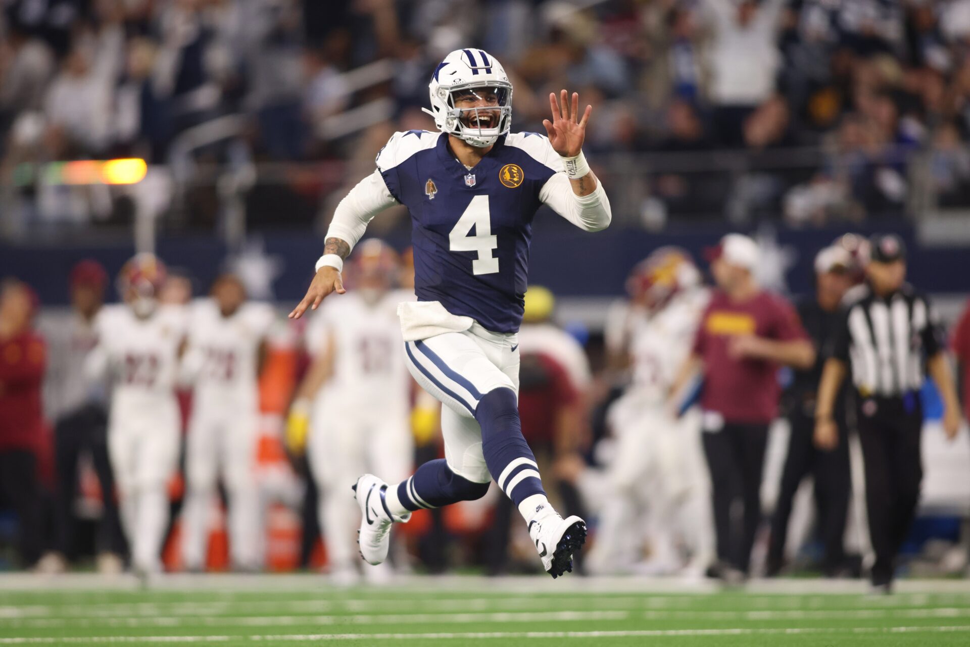 Dallas Cowboys quarterback Dak Prescott (4) celebrates throwing a touchdown in the fourth quarter against the Washington Commanders.