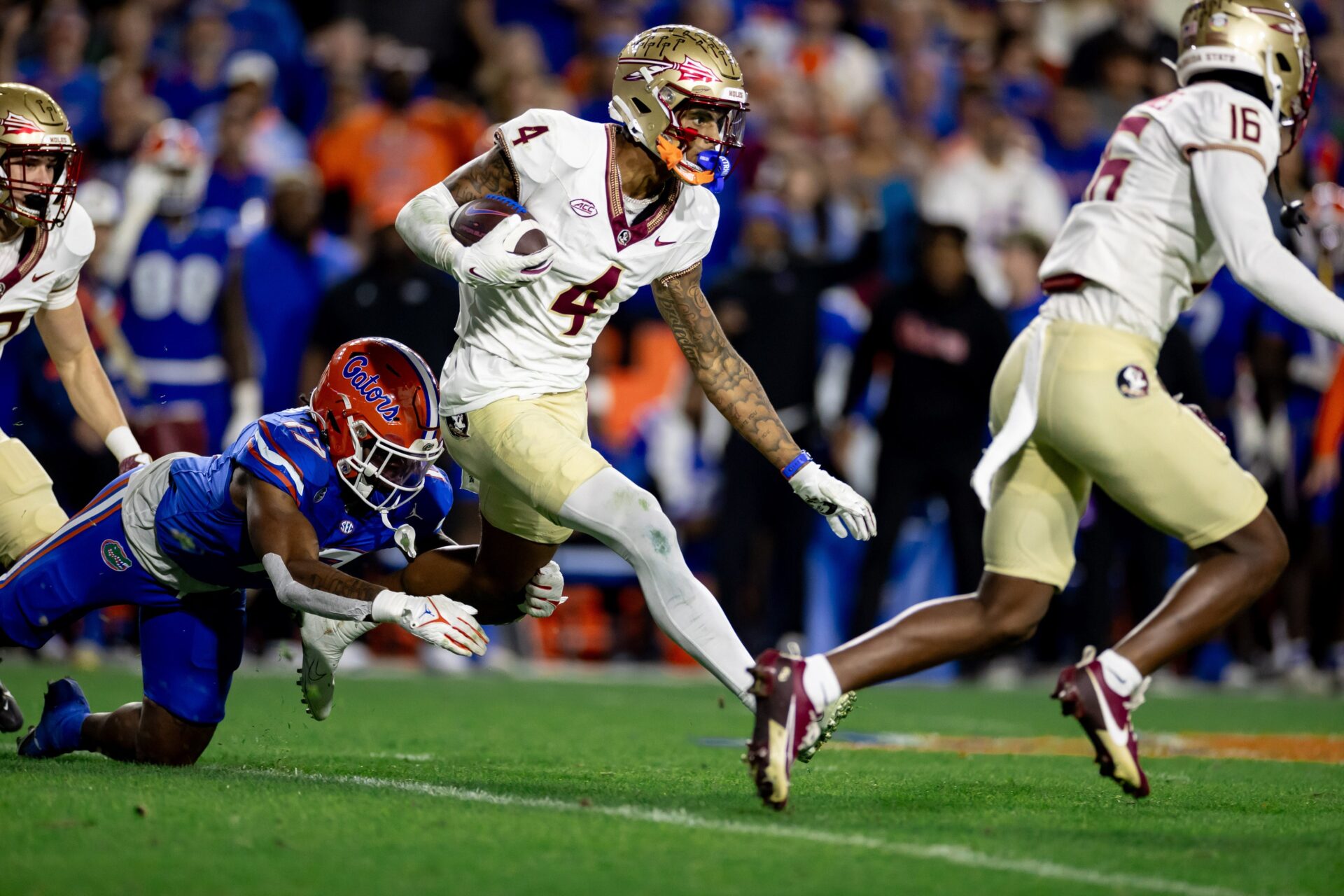 Florida State Seminoles WR Keon Coleman (4) runs with the ball against the Florida Gators.