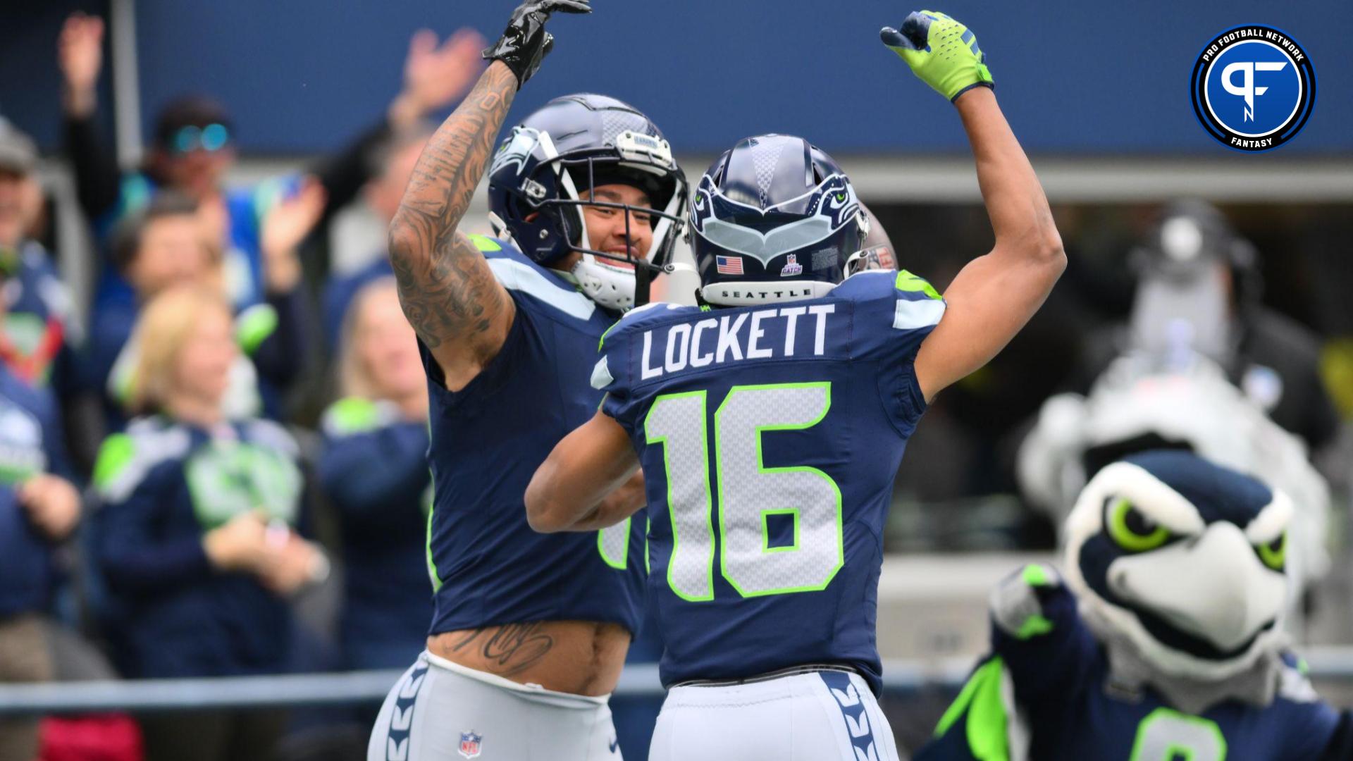 Seattle Seahawks wide receiver Jaxon Smith-Njigba (11) and Seattle Seahawks wide receiver Tyler Lockett (16) celebrate after Jaxon Smith-Njigba scored a touchdown against the Arizona Cardinals during the first half at Lumen Field.