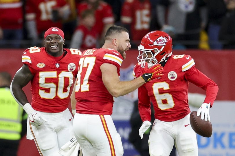 Kansas City Chiefs tight end Travis Kelce (87) congratulates safety Bryan Cook (6) after scoring a touchdown against the Miami Dolphins.