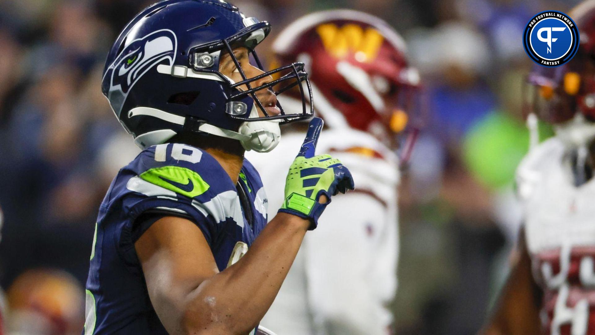 Tyler Lockett (16) reacts after catching a touchdown pass against the Washington Commanders during the fourth quarter at Lumen Field.