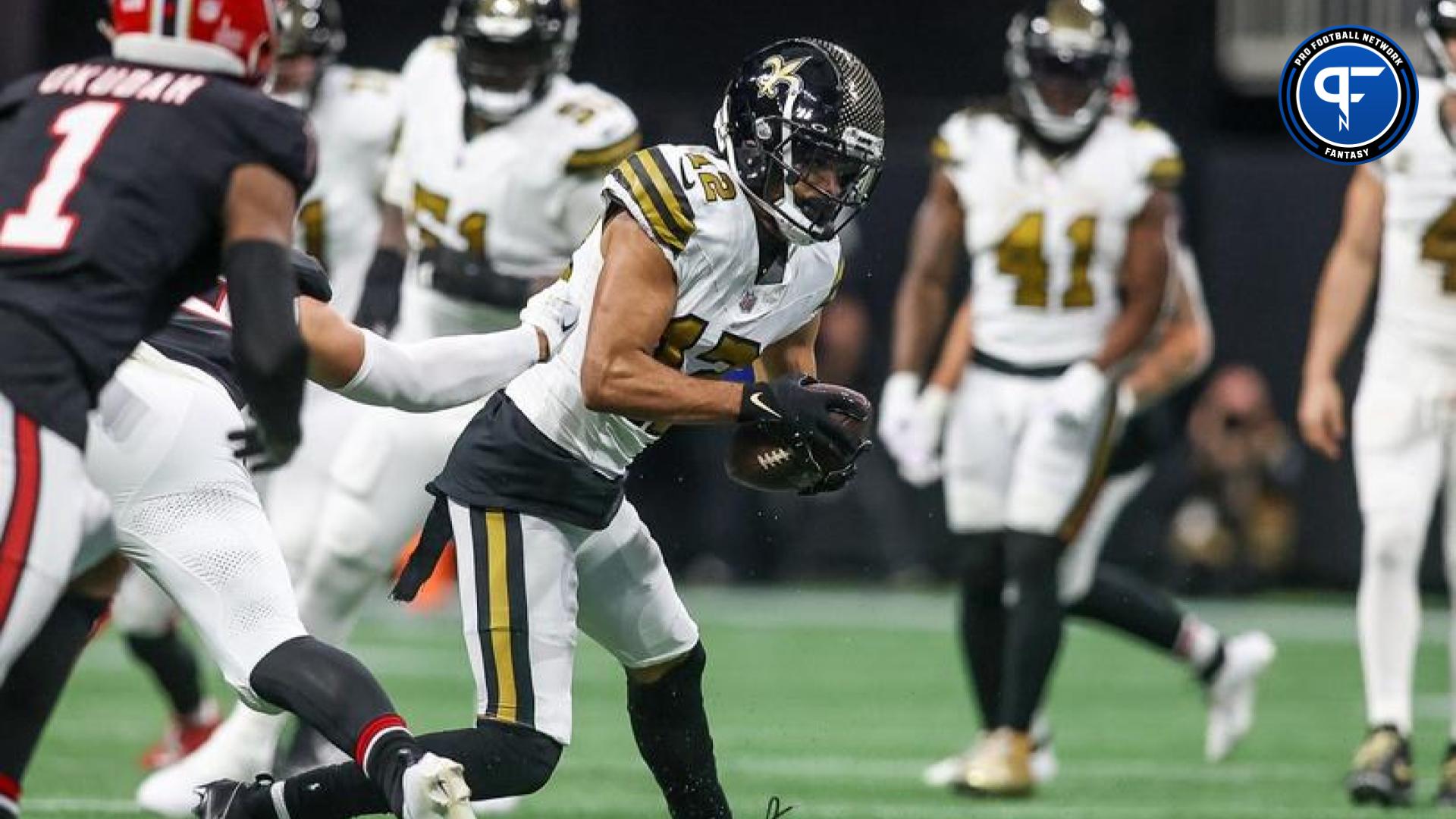 Chris Olave (12) runs after a catch against the Atlanta Falcons in the second quarter at Mercedes-Benz Stadium.