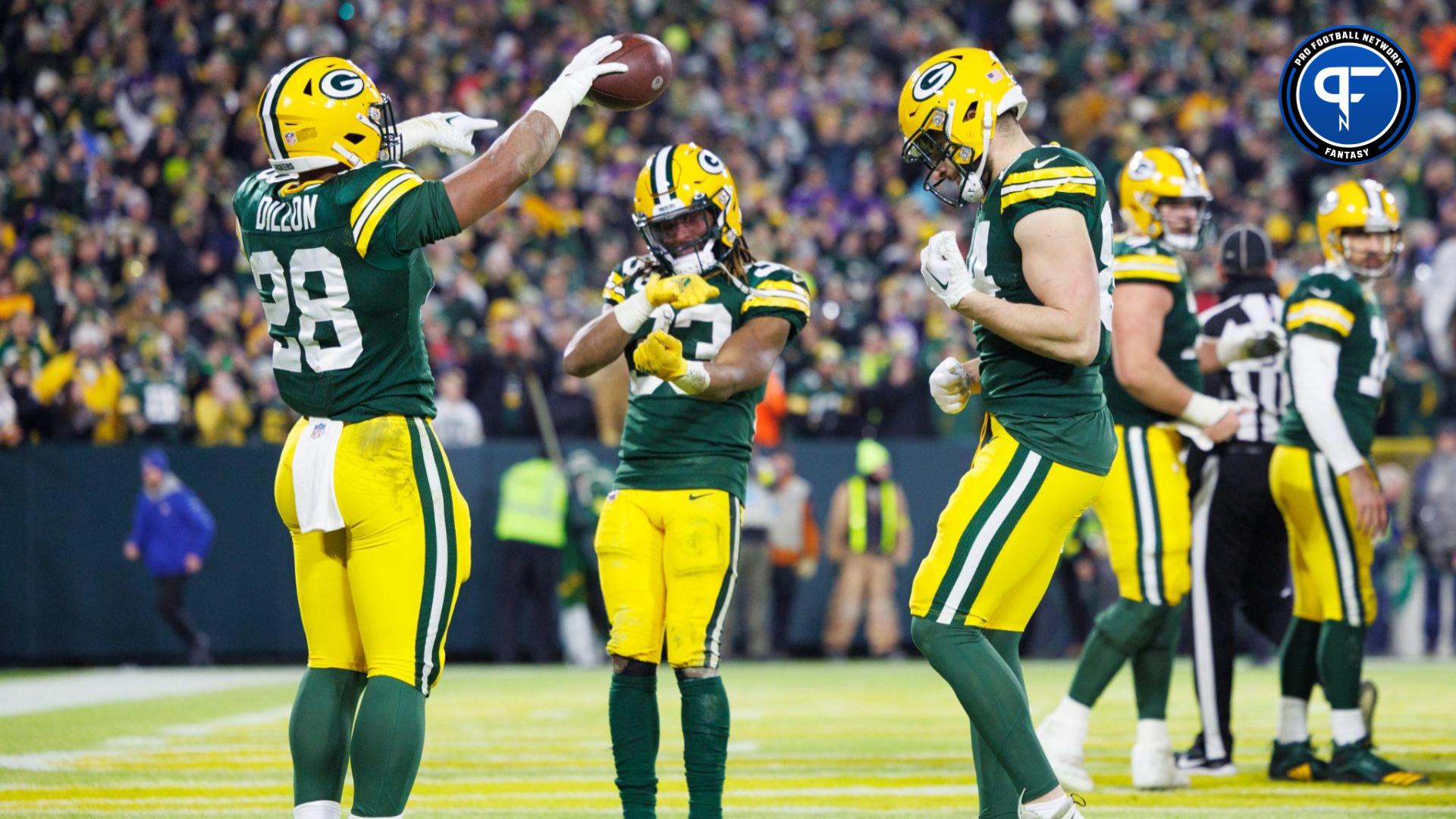 Green Bay Packers running back AJ Dillon (28) celebrates with running back Aaron Jones (33) and tight end Tyler Davis (84) after scoring a touchdown during the fourth quarter at Lambeau Field.