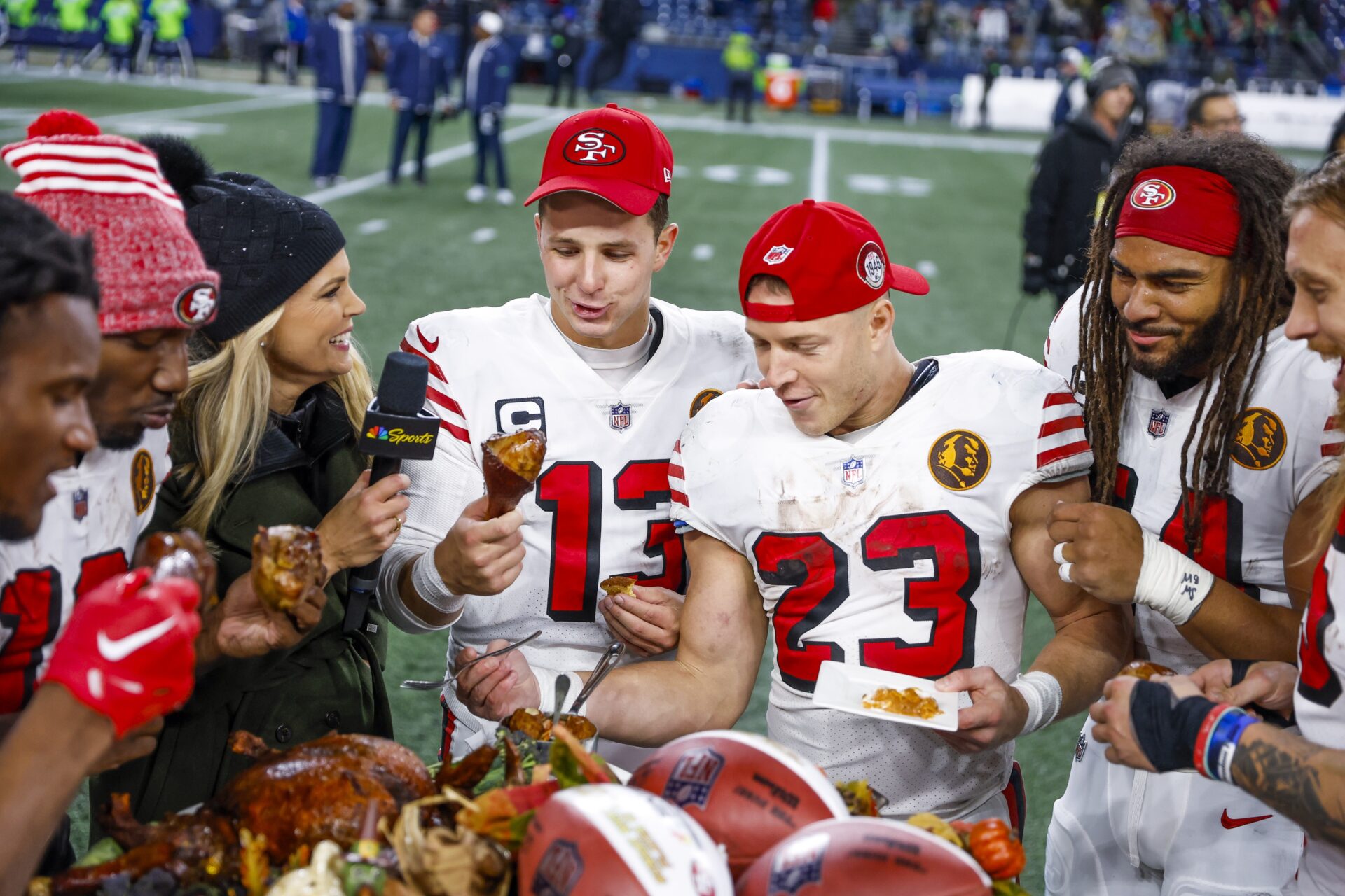 San Francisco 49ers quarterback Brock Purdy (13), running back Christian McCaffrey (23) and San Francisco 49ers linebacker Fred Warner (54) partake in a turkey dinner following a 31-13 victory against the Seattle Seahawks.