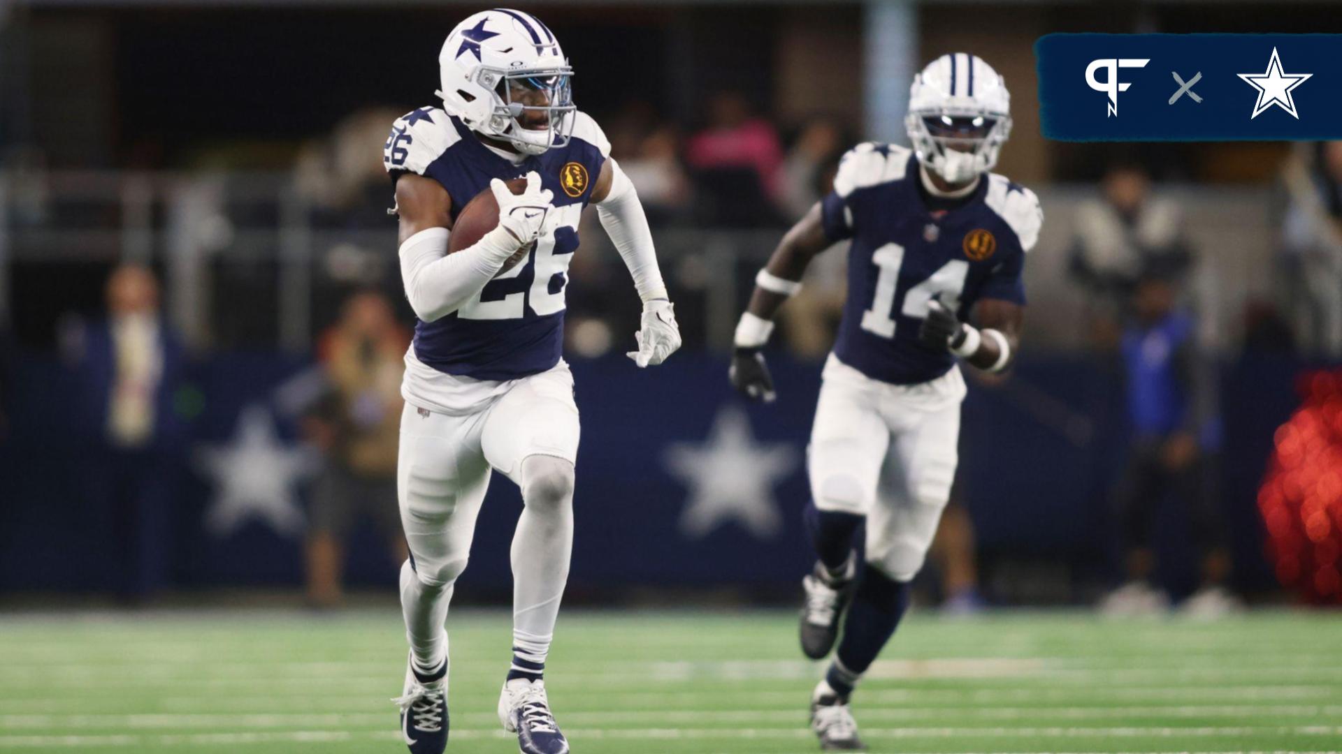 Dallas Cowboys cornerback DaRon Bland (26) returns an interception for a touchdown in the fourth quarter against the Washington Commanders at AT&T Stadium.
