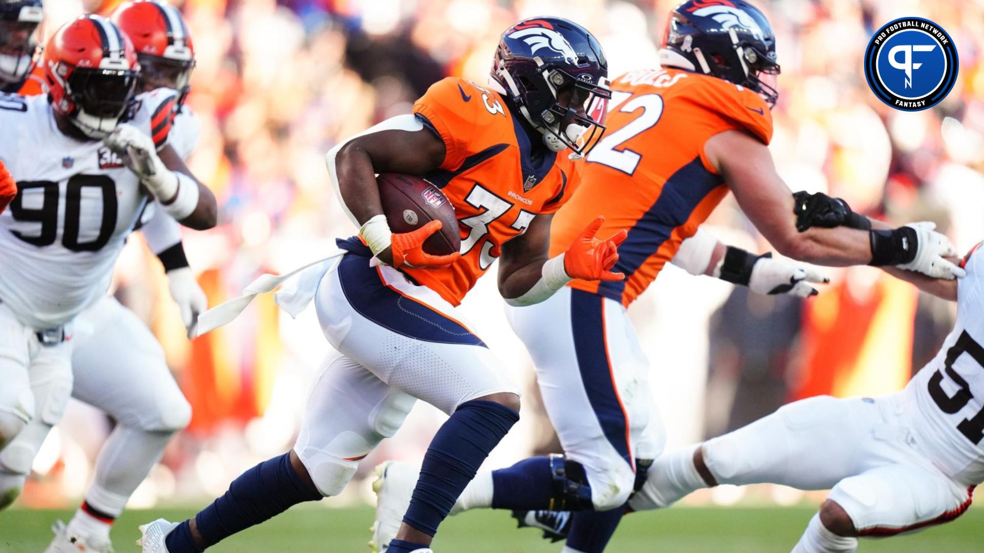 Javonte Williams (33) carries the ball in the second quarter against the Cleveland Browns at Empower Field at Mile High.