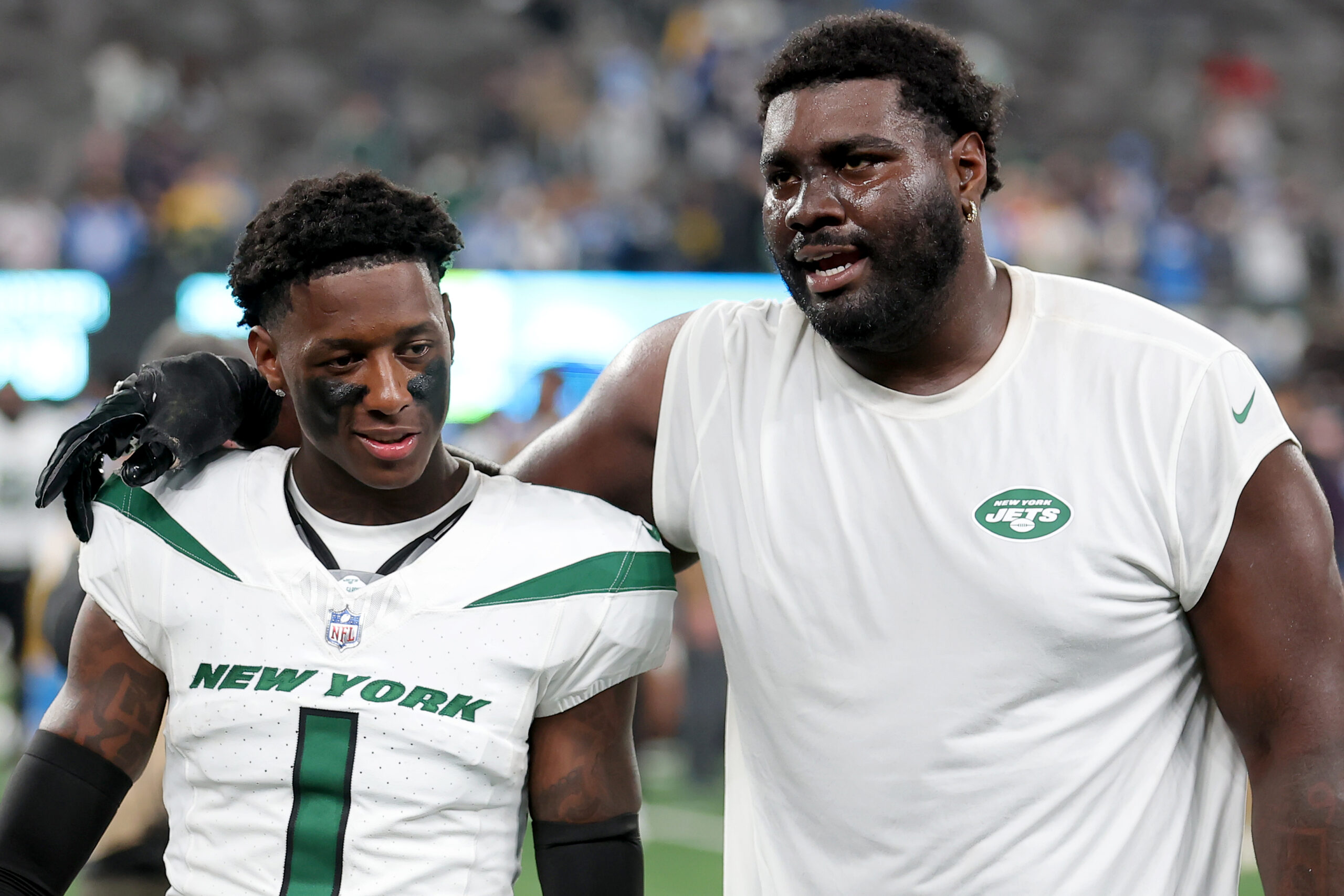 New York Jets cornerback Sauce Gardner (1) and offensive tackle Mekhi Becton (77) walk off the field after losing to the Los Angeles Chargers at MetLife Stadium.