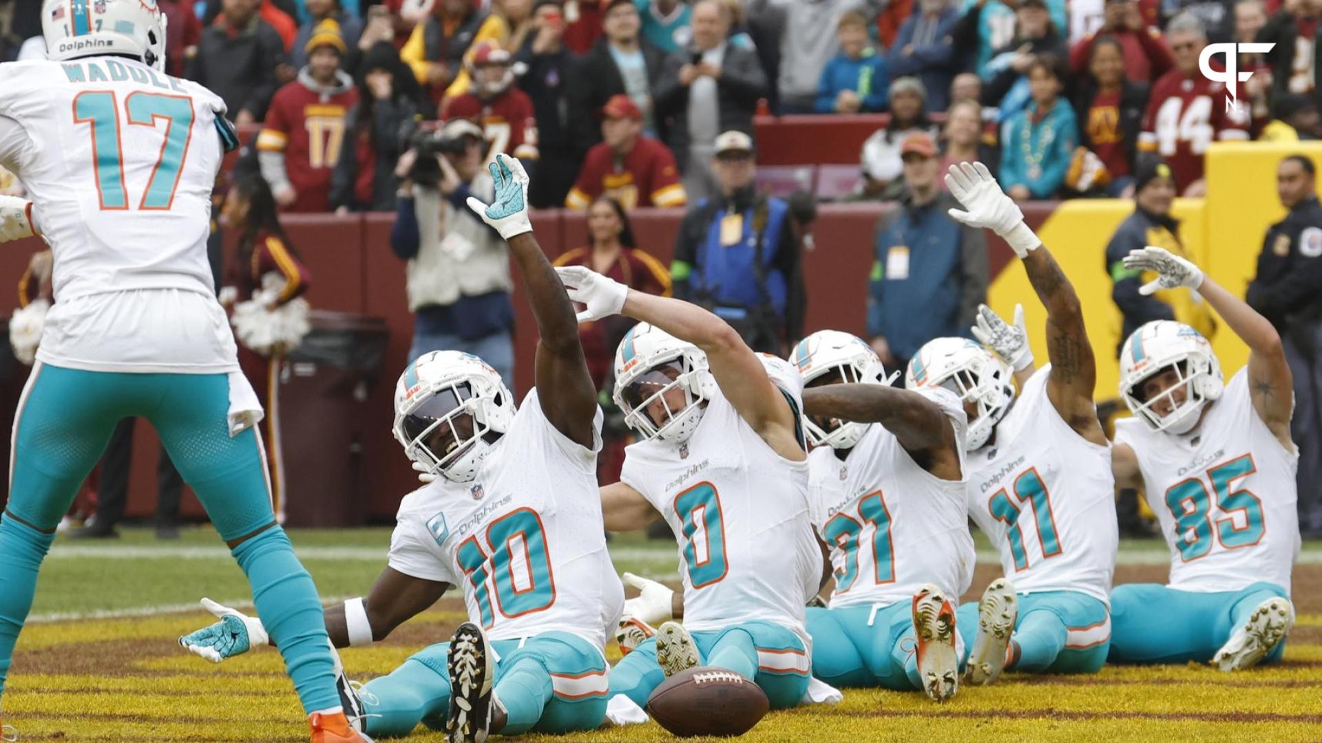 Miami Dolphins wide receiver Tyreek Hill (10) celebrates with teammates in the end zone after catching a touchdown pass against the Washington Commanders during the first quarter at FedExField.