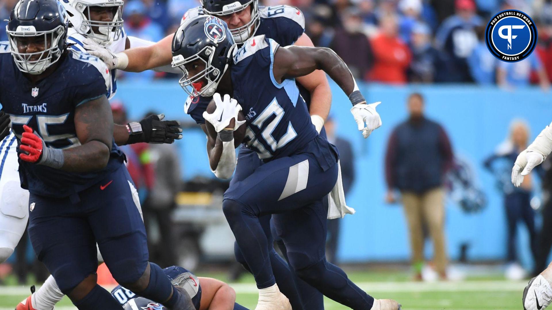 Tennessee Titans running back Tyjae Spears (32) runs for a short gain in overtime against the Indianapolis Colts at Nissan Stadium.
