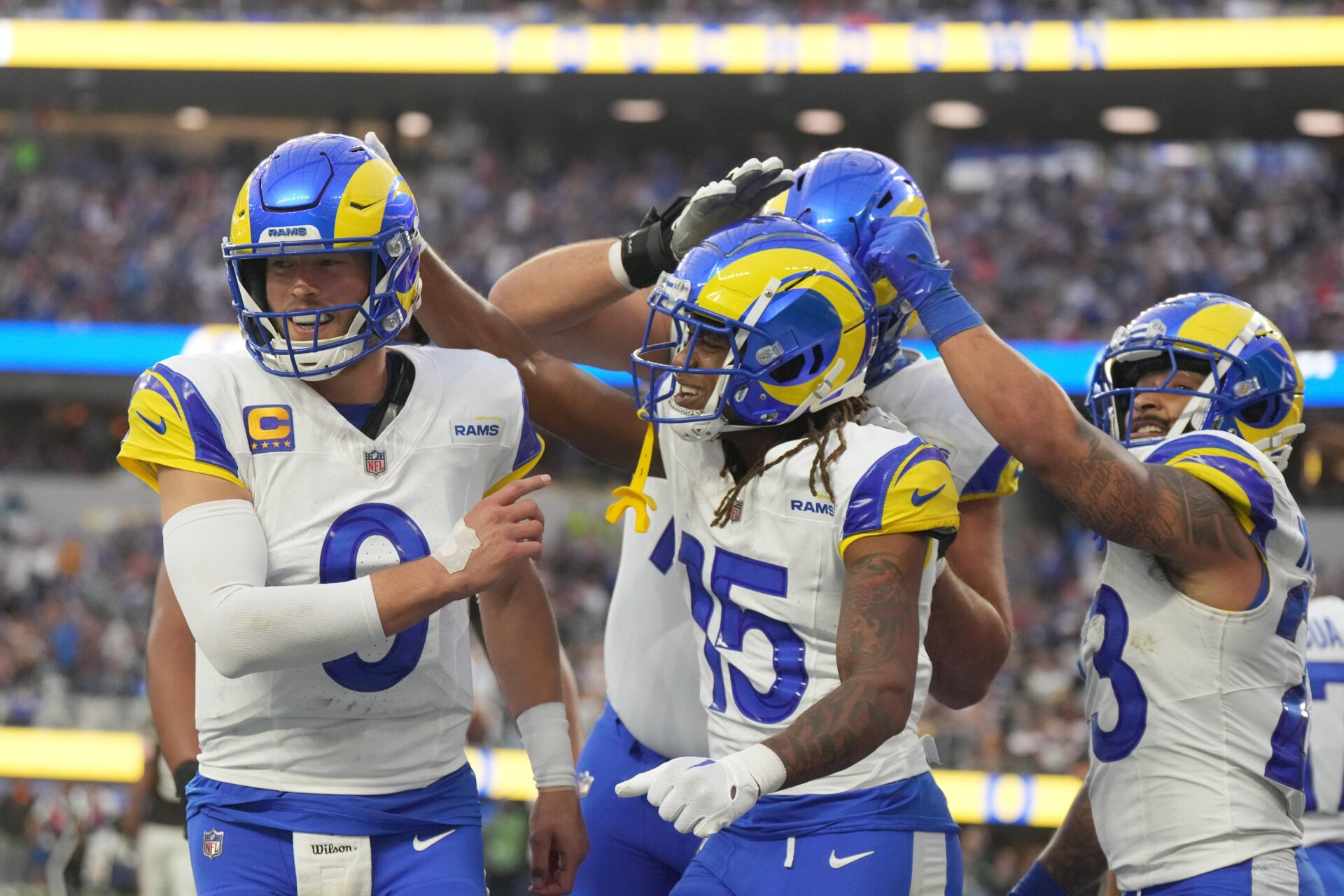 Los Angeles Rams wide receiver Demarcus Robinson (15) celebrates with quarterback Matthew Stafford (9) and running back Kyren Williams (23) after catching a 7-yard touchdown pass in the third quarter against the Cleveland Browns at SoFi Stadium.
