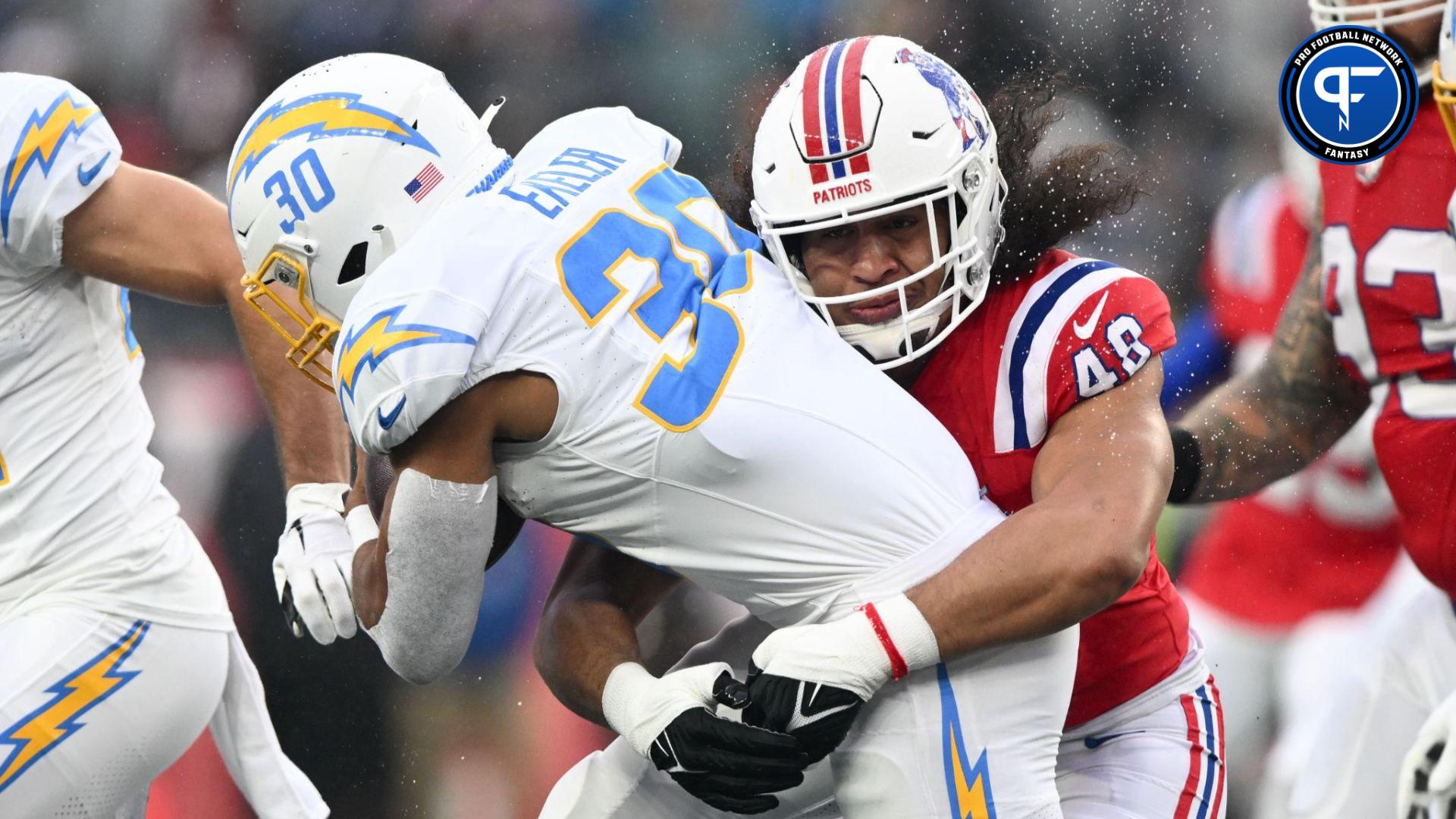 New England Patriots linebacker Jahlani Tavai (48) tackles Los Angeles Chargers running back Austin Ekeler (30) during the first half at Gillette Stadium.