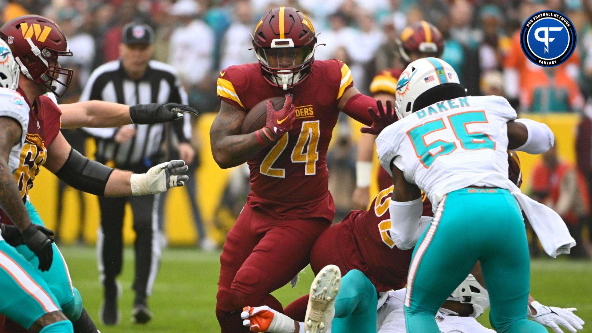 Washington Commanders running back Antonio Gibson (24) carries the ball against the Miami Dolphins during the first half at FedExField.