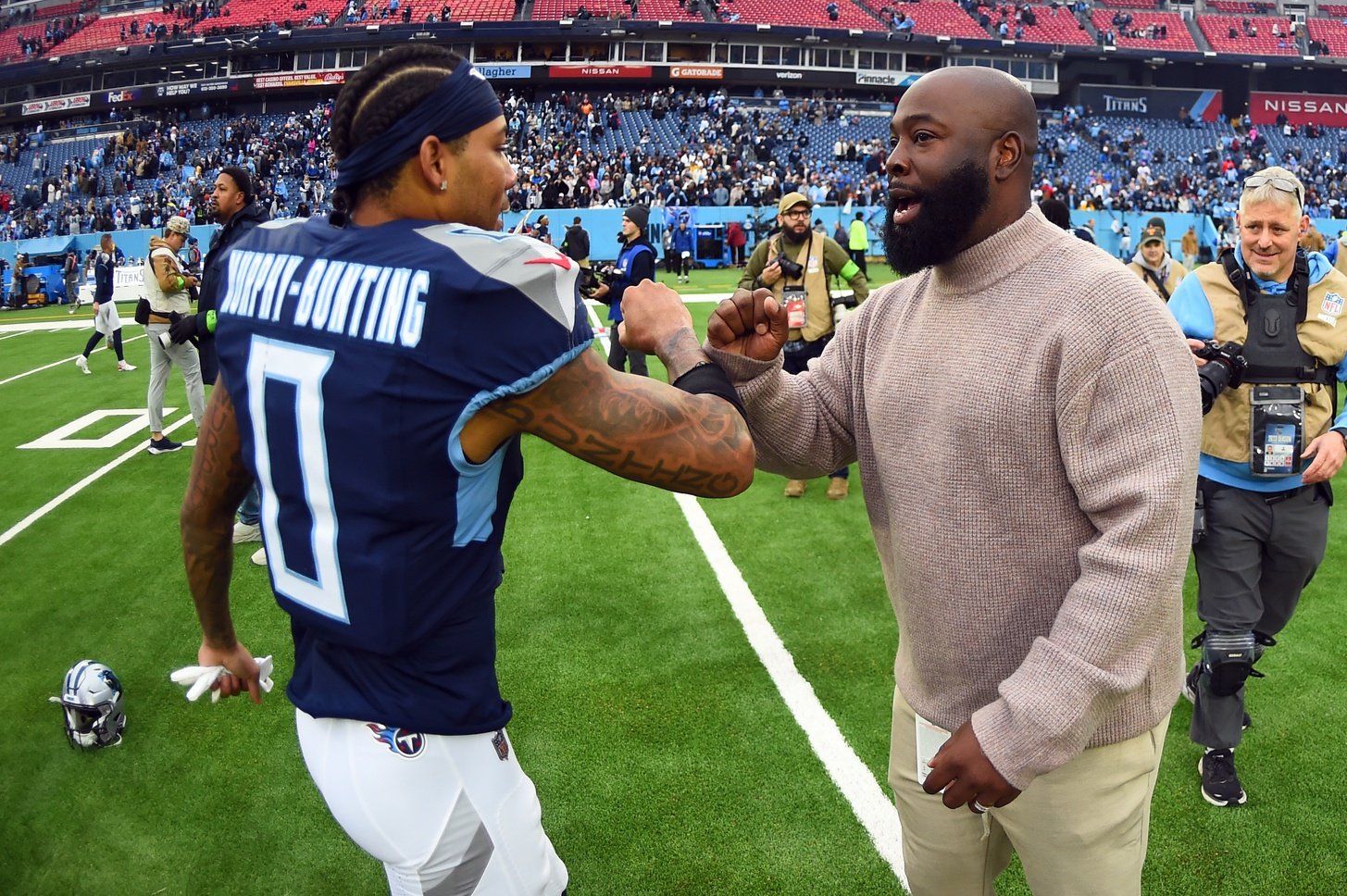 Tennessee Titans general manager Ran Carthon celebrates with cornerback Sean Murphy-Bunting (0) after a win against the Carolina Panthers at Nissan Stadium.