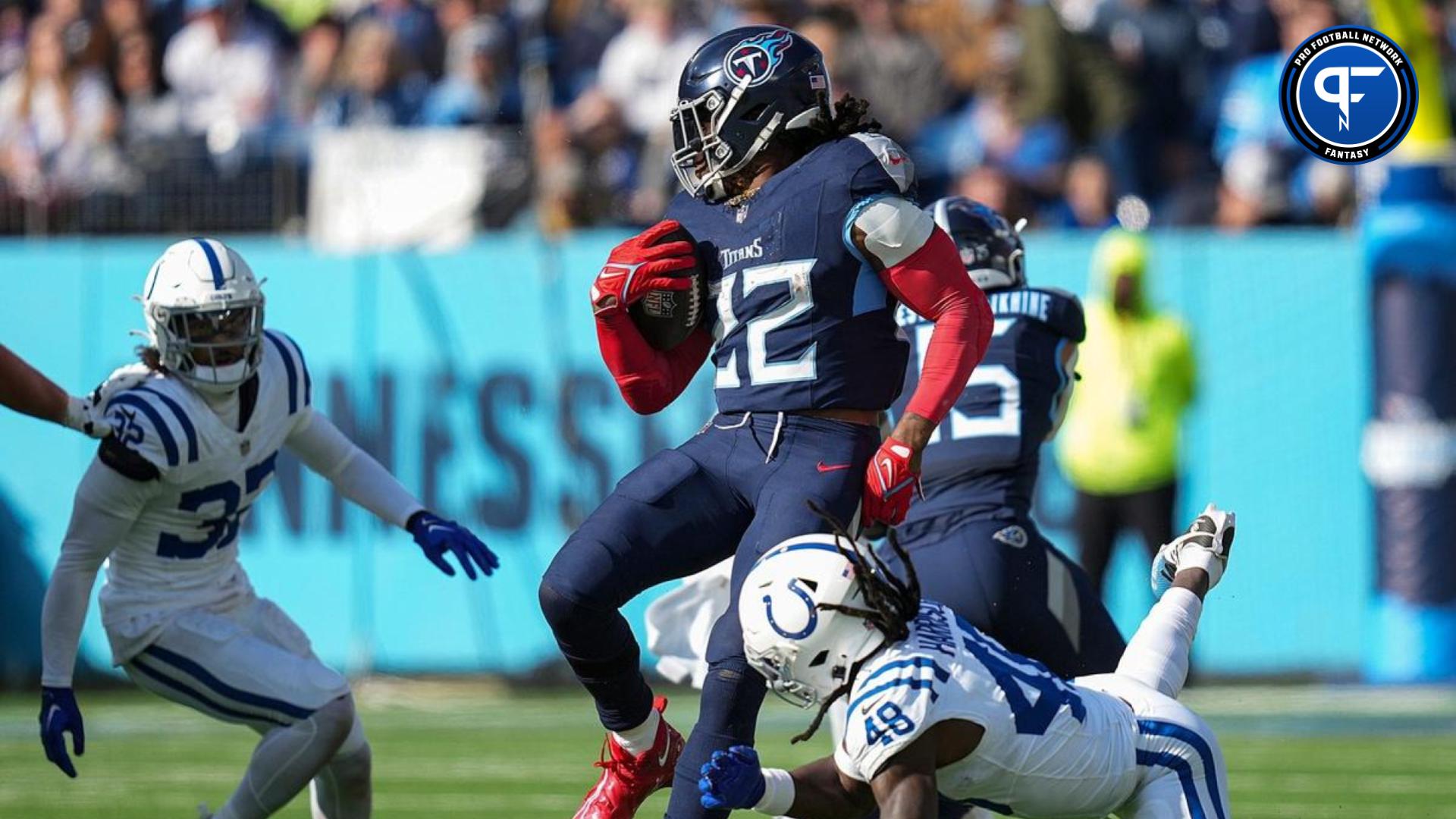 Tennessee Titans running back Derrick Henry (22) slips away from Indianapolis Colts safety Ronnie Harrison Jr. (48) for a Titans first down.