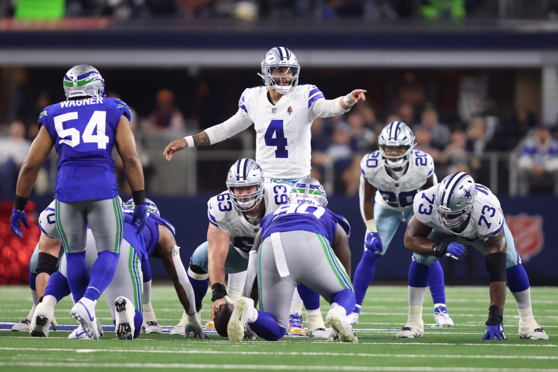 Dallas Cowboys quarterback Dak Prescott (4) gestures at the line of scrimmage during the first half against the Seattle Seahawks.