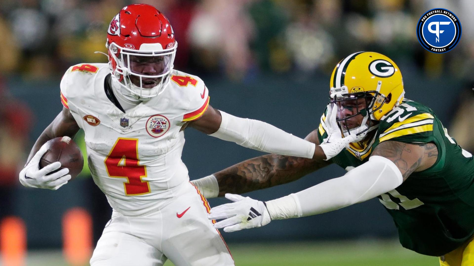 Kansas City Chiefs wide receiver Rashee Rice (4) stiff arms Green Bay Packers linebacker Preston Smith (91) during their football game Sunday, December 3, 2023, at Lambeau Field in Green Bay, Wis.