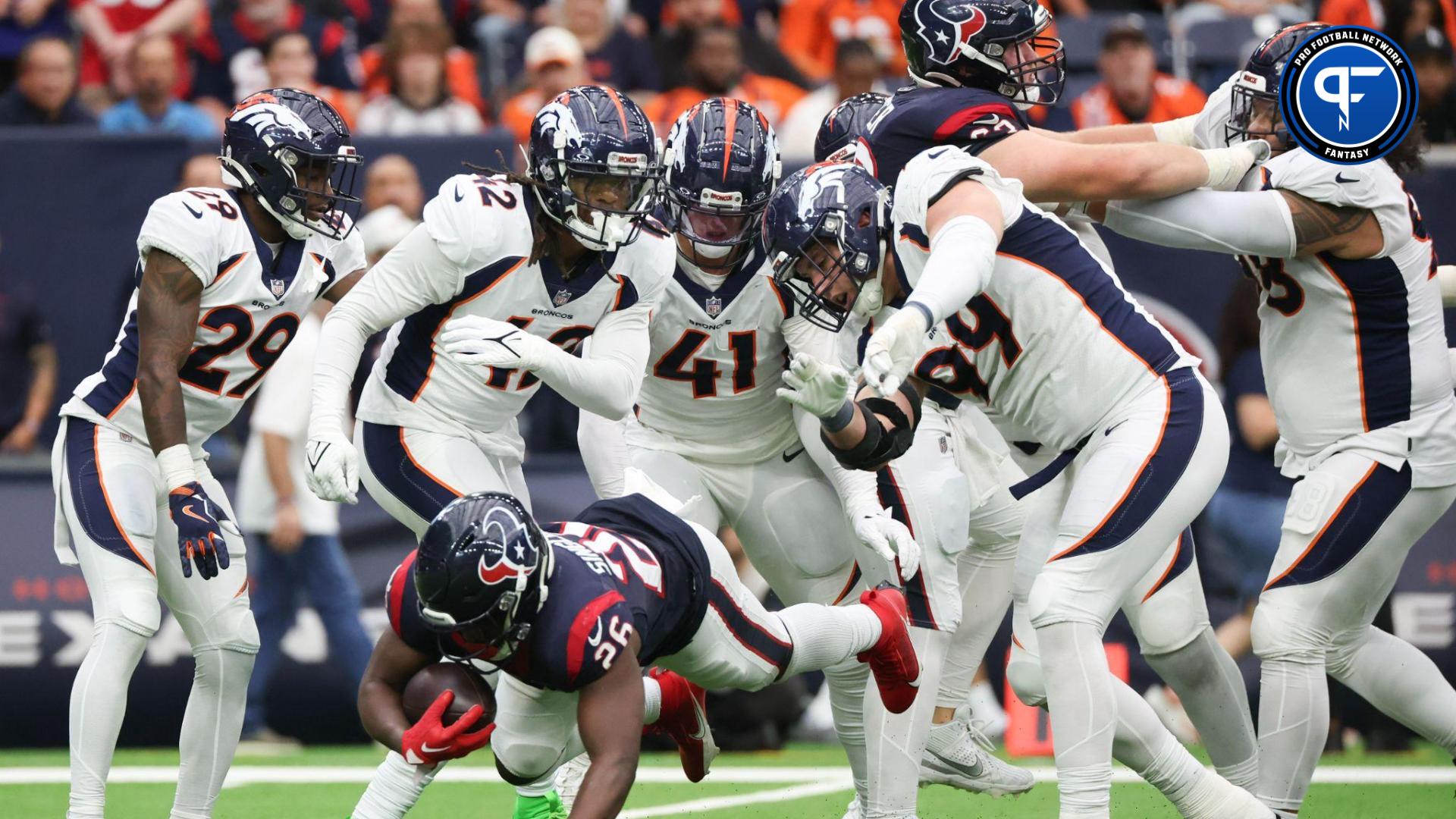 Houston Texans running back Devin Singletary (26) is tackled by Denver Broncos defensive end Zach Allen (99) and teammates for a loss in the second half at NRG Stadium.