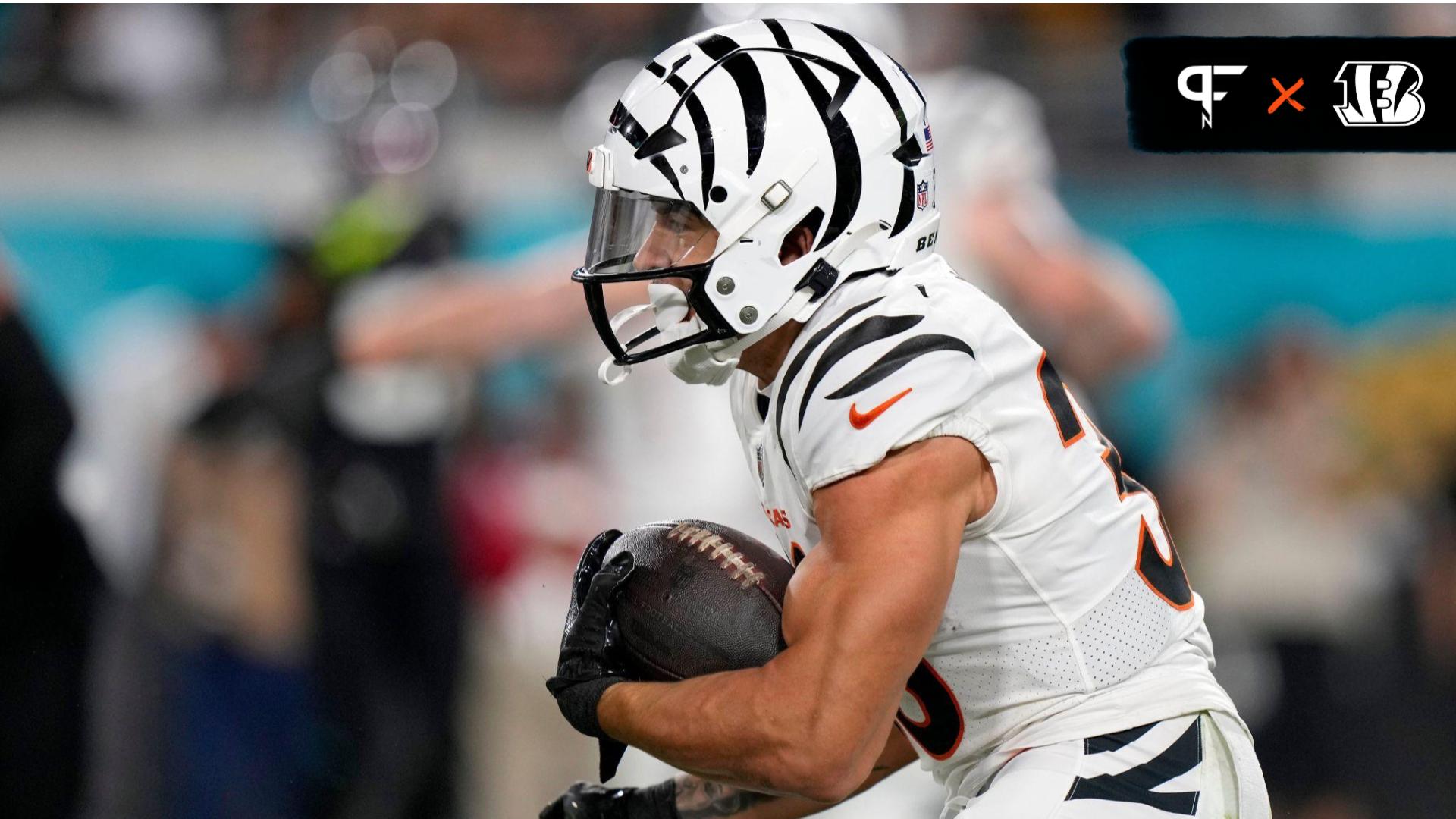 Chase Brown (30) takes a carry from Cincinnati Bengals quarterback Jake Browning (6) in the first half of a Week 13 NFL football game against the Jacksonville Jaguars.