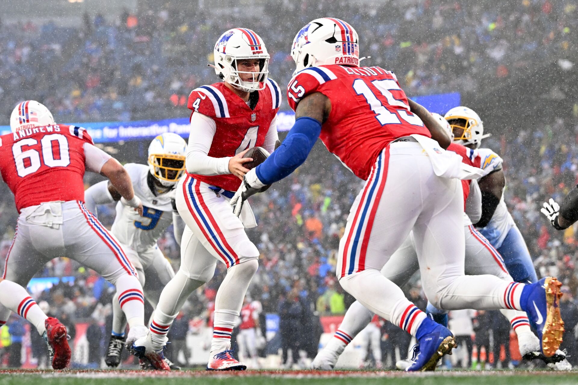 New England Patriots quarterback Bailey Zappe (4) hands the ball off to running back Ezekiel Elliott (15) during the second half of a game against the Los Angeles Chargers at Gillette Stadium.