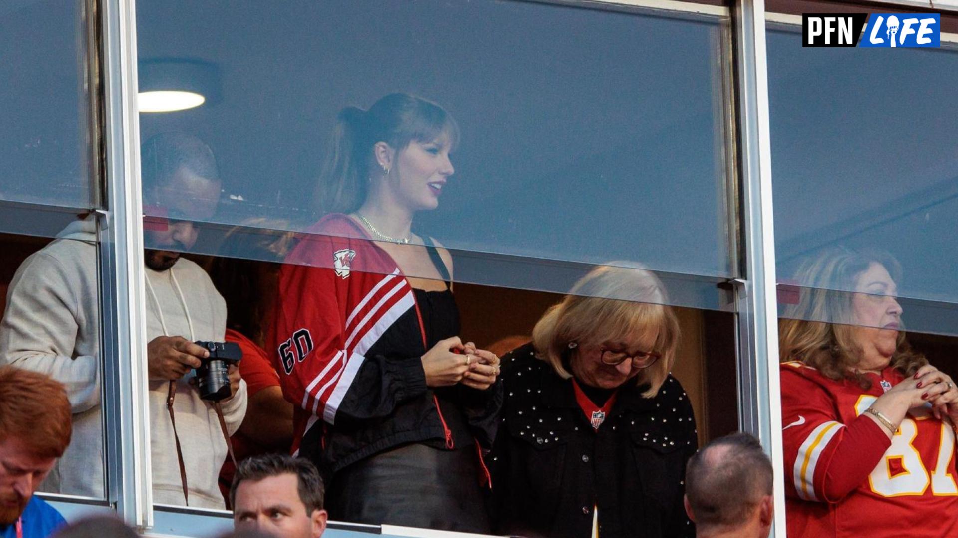 Grammy award winning artist Taylor Swift watches Kansas City Chiefs take the field along with Kansas City Chiefs tight end Travis Kelce (87) mom Donna Kelce prior to the game against the Denver Broncos.