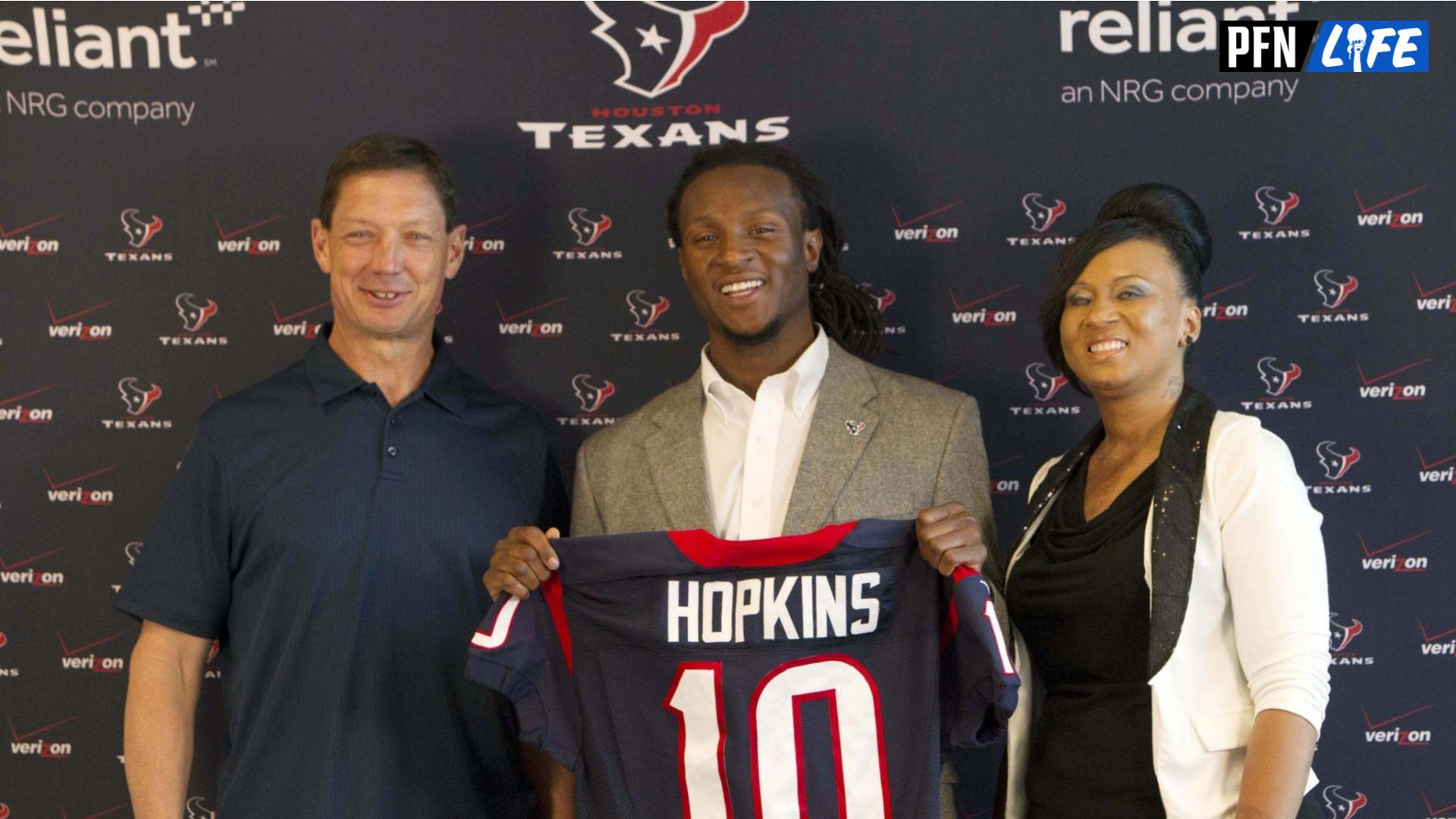 Houston Texans first-round draft pick wide receiver DeAndre Hopkins poses for a picture with offensive coordinator Rick Dennison and mother Sabrina Greenlee during a press conference.