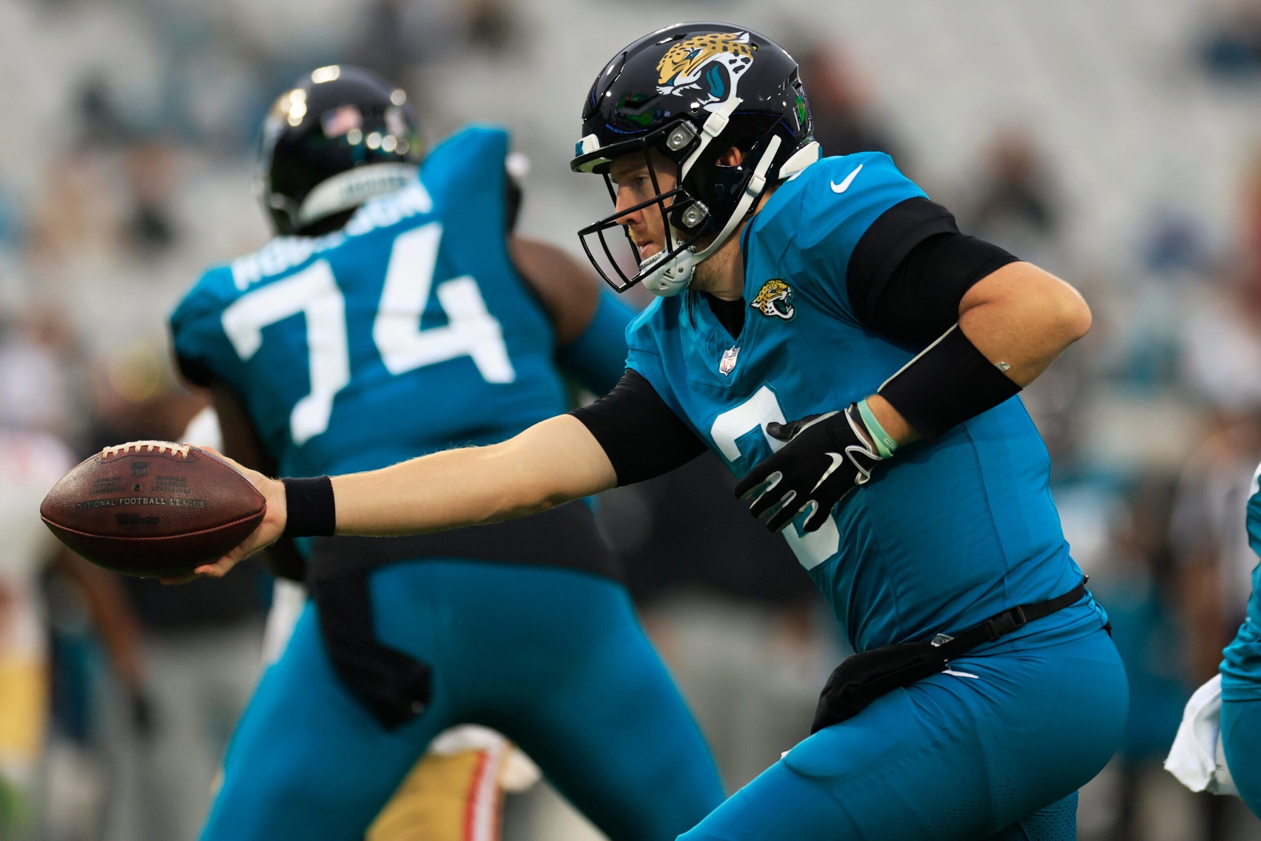 C.J. Beathard (3) hands off to running back Tank Bigsby (4), not shown, during the fourth quarter.