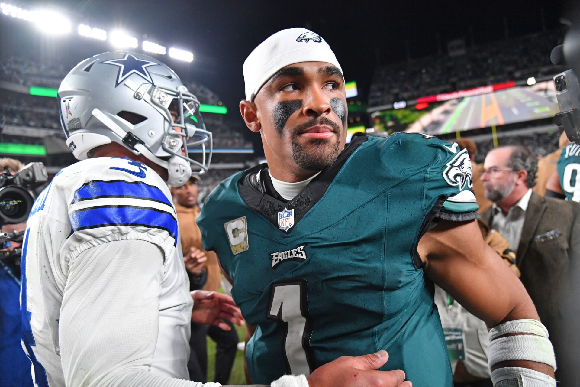 Quarterbacks Dak Prescott (left) and Jalen Hurts (right) meet on the field after the Philadelphia Eagles' victory over the Dallas Cowboys.