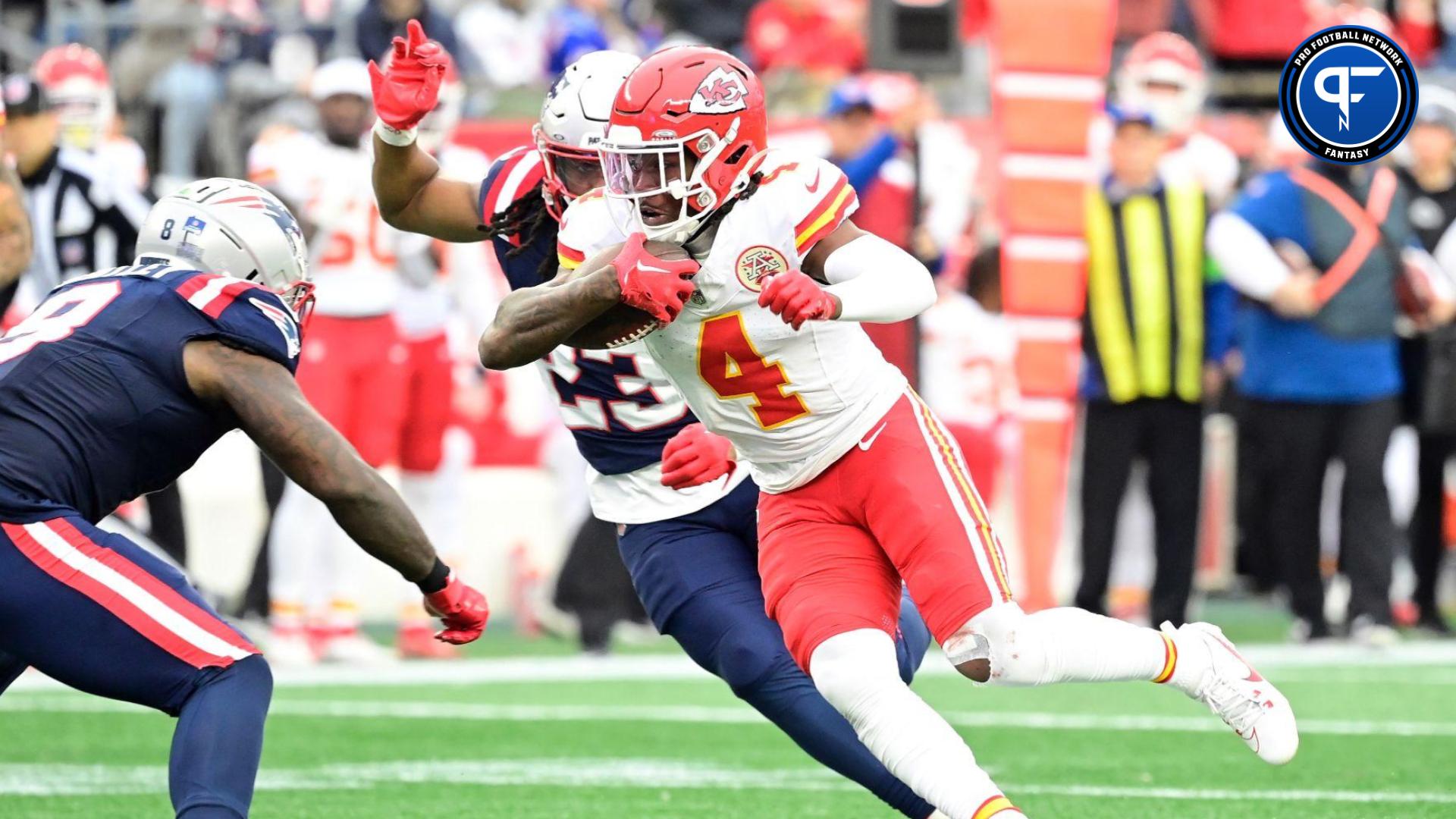 Kansas City Chiefs wide receiver Rashee Rice (4) runs the ball as New England Patriots safety Kyle Dugger (23) chases him during the first half at Gillette Stadium.