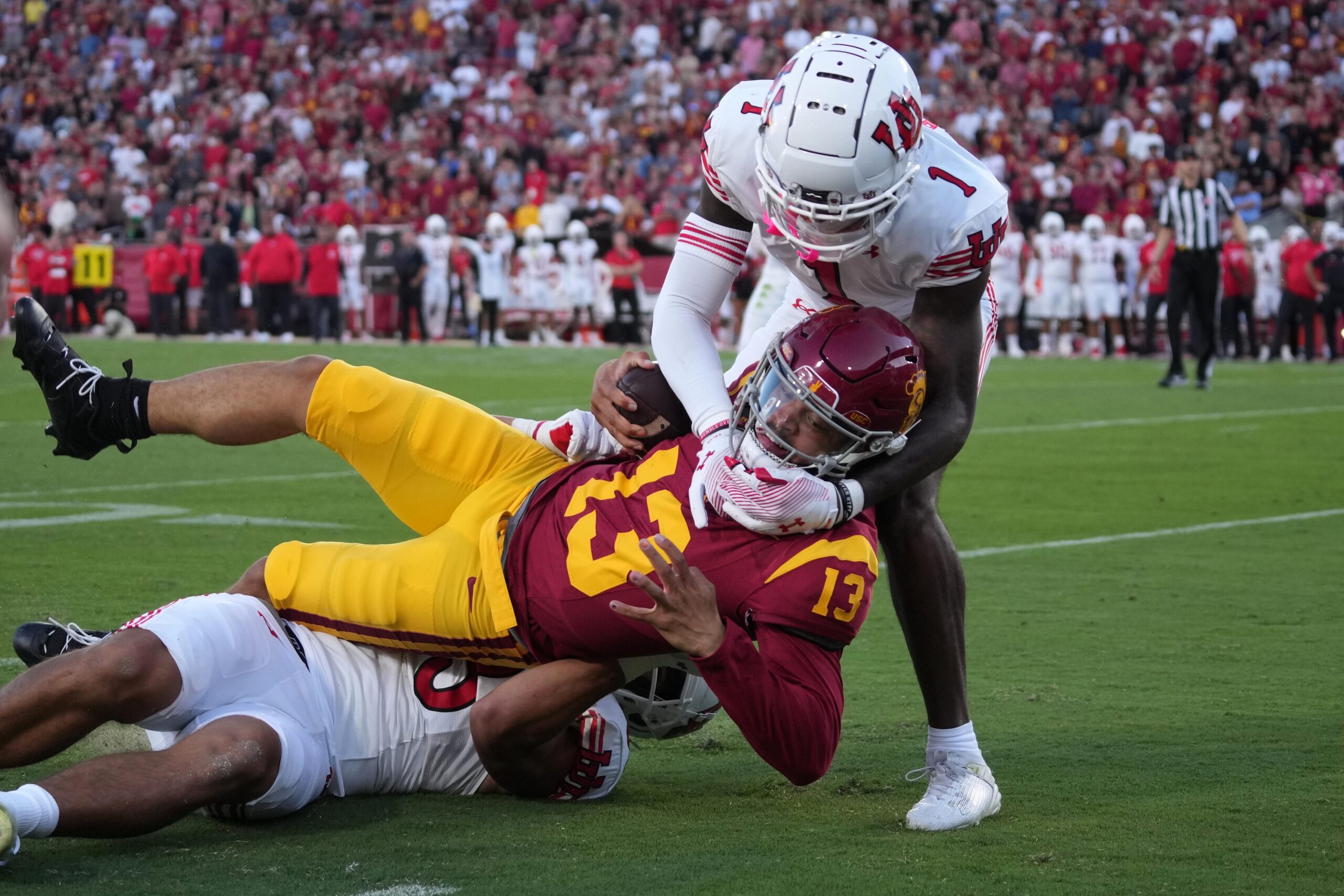 Southern California Trojans quarterback Caleb Williams (13) carries the ball against Utah Utes cornerback Miles Battle (1) and defensive end Jonah Elliss (83) in the first half at United Airlines Field at Los Angeles Memorial Coliseum.