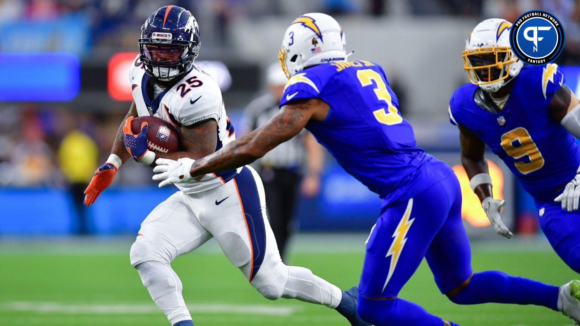 Denver Broncos running back Samaje Perine (25) runs the ball against Los Angeles Chargers safety Derwin James Jr. (3) during the second half at SoFi Stadium.